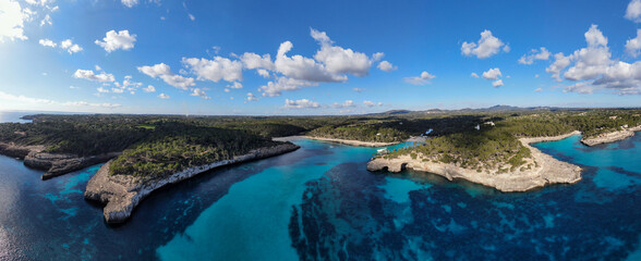  Panoramic photo of the beach in Mallorca. Beautiful view of the seacoast of Mallorca with an amazing turquoise sea, in the middle of the nature. Concept of summer, travel, relax and enjoy.
