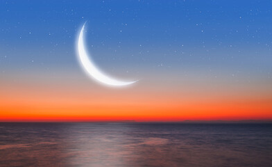 Fototapeta na wymiar Ramadan Kareem background -Crescent moon over the sea at amazing sunset 