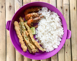 meal box of rice with side dish, fried prawns and crispy fried beans.