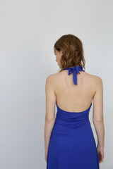 Obraz premium Woman in royal blue midi halter A line dress. Easy summer fashion. Studio shot. 