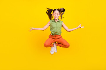 Photo of sweet funky student girl wear green shirt smiling jumping high practicing yoga isolated...