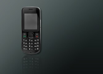 Old retro mobile phone on dark background