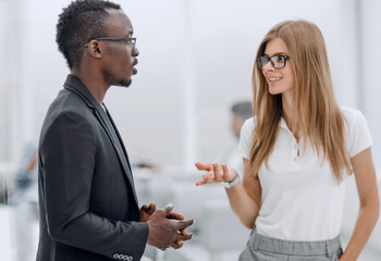 afro american guy and girl talking in the office