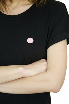 Small button badge pinned onto black shirt