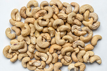 Handful of cashew nuts scattered on the table surface