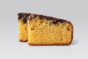 Two slices of chocolate muffin on a light background