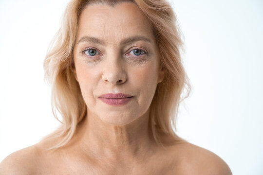 Horizontal shot of the calm middle aged woman with perfect skin