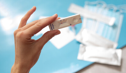 Close up hand of woman holds antigen test on coronavirus. Make fast test at home and get results....