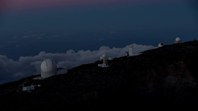 Time lapse of sunset and clouds behind Roque de los Muchachos Observatory (ORM) with telescopes on La Palma Island, Canary Islands, Spain