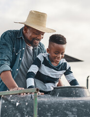 One fun tractor ride deserves another. Shot of a mature man helping his adorable son ride a tractor on a farm.