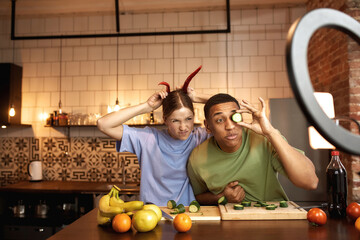 Blogger couple joking with vegetables for video