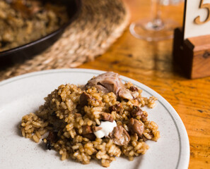 appetizing racy paella montana with mushrooms and pork trotters