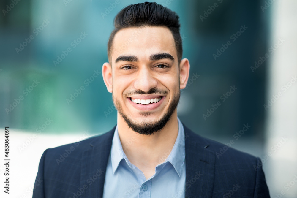 Wall mural closeup portrait of happy middle-eastern young businessman