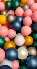 bright festive multi colored small plastic balls are scattered with a colored background