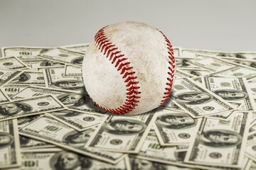 Baseball ball with cash money. Major league strike, lockout and sports betting concept.