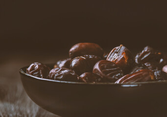 Mix of dates and nuts in plate on a white wood background .healthy food