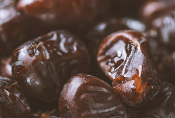 Mix of dates and nuts in plate on a white wood background .healthy food