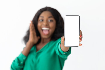 Emotional black woman showing cellphone with blank screen