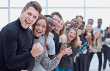 group of happy young people standing behind each other