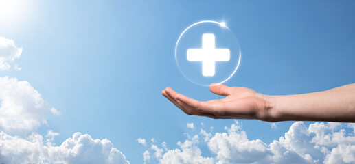 Businessman hold virtual plus medical network connection icons. Covid-19 pandemic develop people awareness and spread attention on their healthcare.