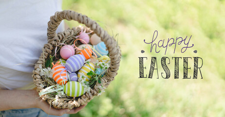 Happy easter card. Funny teen girl with eggs basket and bunny ears on Easter egg hunt in sunny...