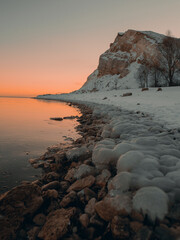 Brown rocky mountain beside body of water