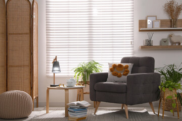 Comfortable place for rest with armchair near window in room
