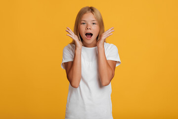 Scared surprised shocked european teenager girl in white t-shirt screaming with open mouth