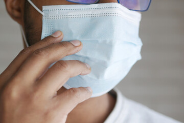 Close up of man with protective face mask taking deep breath 