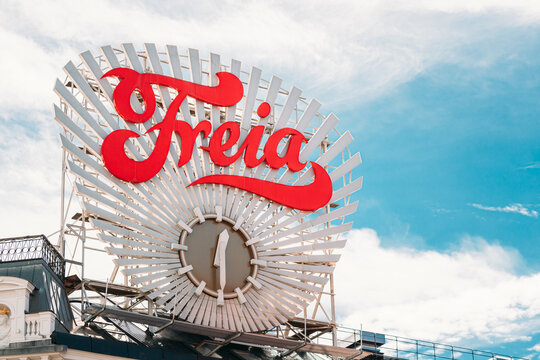 Oslo, Norway - June 24, 2019: Close Up The Freia Sign. Old Commercial Sign For The Norwegian Chocolate Freia. Norwegian chocolate sweets manufacturing company Freia clock at Egertorget square.