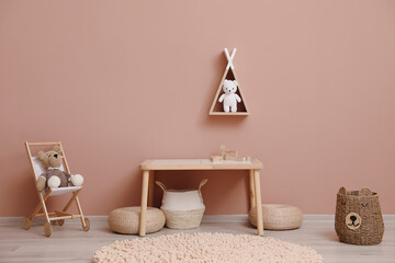 Cute child room interior with furniture, toys and wigwam shaped shelf on pink wall © New Africa