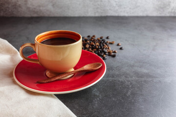 Coffee cup and coffee beans on table