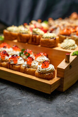 Close-up of rolls with red caviar on wooden substrate, japanese menu