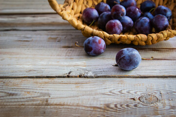 Plums on wooden background.