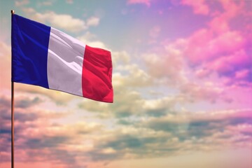 Fluttering France flag mockup with the space for your content on colorful cloudy sky background.