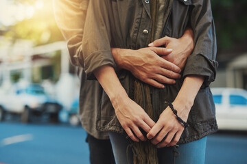 Fototapeta premium Nothing feels safer than his arms. Cropped shot of an affectionate couple in the city.