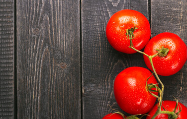 Fototapeta na wymiar Ripe red tomatoes top view with copy space on wood background. Nature food background