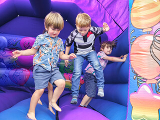 Children jumping in bouncy castle