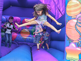 Children jumping in bouncy castle