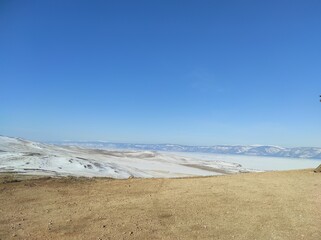 ground with snow against the blue sky