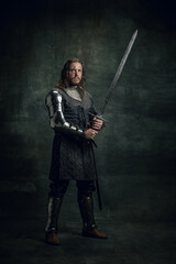 Vintage style portrait of brutal seriuos man, medieval warrior or knight with dirty wounded face...