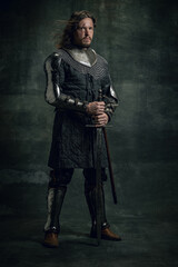 Vintage style portrait of brutal seriuos man, medieval warrior or knight with dirty wounded face...