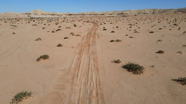 Aerial view of a racing car running the international rally event in Saudi Arabian desert near Riyadh