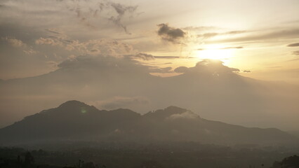 sunrise over the mountains in cloudy weather. This is taken from Famous spot to see sunrise named Mangli Sky View. The place is named 