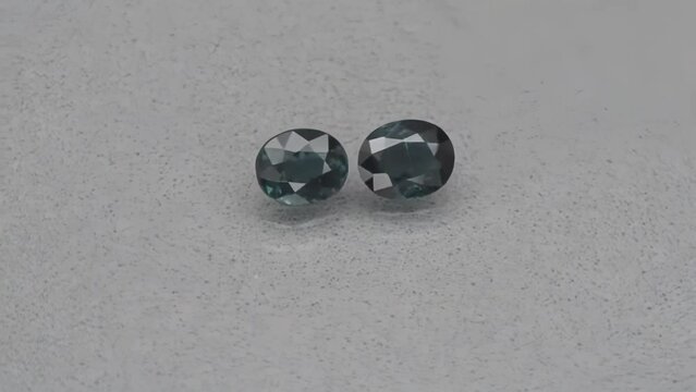 natural indicolite tourmaline gem stone on the turning table. grey background