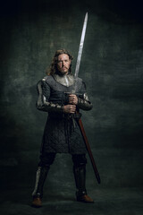 Vintage style portrait of brutal seriuos man, medieval warrior or knight with dirty wounded face...