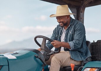 What's a farmer without his tractor. Shot of a mature man driving a tractor on a farm.