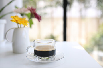 Glass cup and vase of gerbera flower