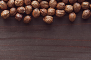Close up brown hazel nut on wooden desk. Healthy organic vegetarian snack hazelnut. Place for text