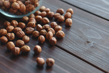 Close up brown hazel nut on wooden desk. Healthy organic snack hazelnut. Vegetarian nutrition.